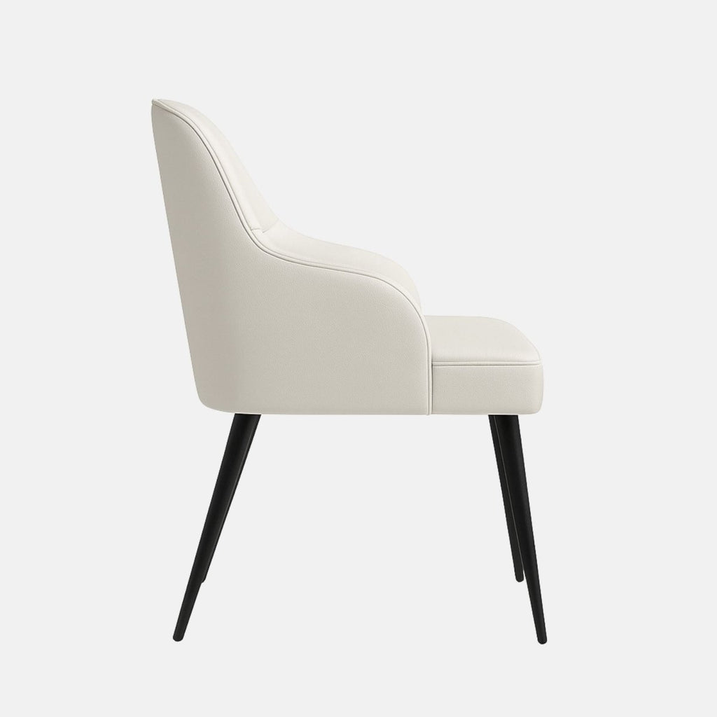 Modern dining chair with pearl white upholstered backrest and seat, subtle ruched detailing, integrated armrests, and slim tapered black legs