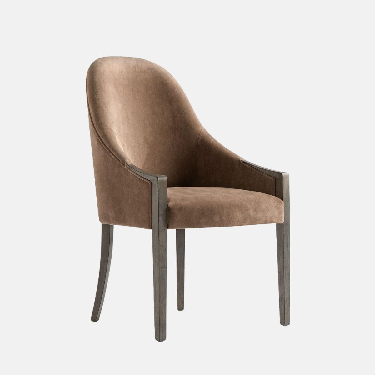 Upholstered dining chair in warm taupe-brown fabric with a rounded backrest, subtle arm supports, cushioned seat, and dark wooden legs, shown on a white background