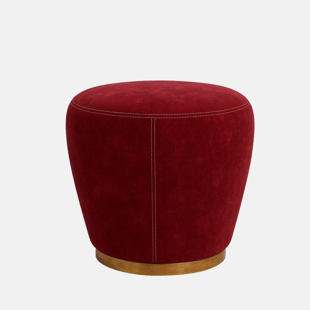 Red velvet round stool with gold metal base and contrast stitching modern upholstered ottoman or accent seat for living room, bedroom, or hotel lounge.