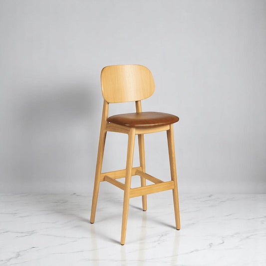alt="Stylish Italian-style bar stool with upholstered seat and smooth natural oak finish"