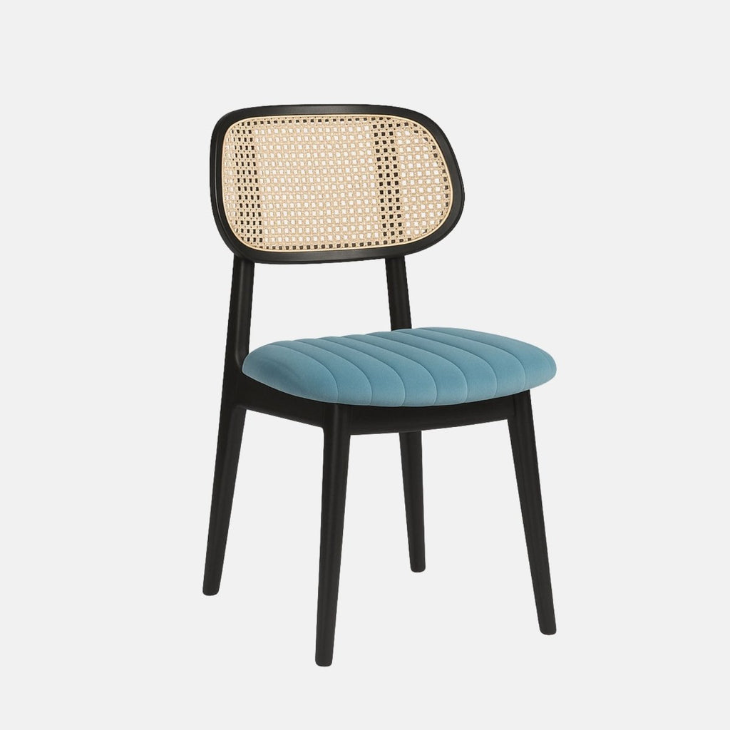 Modern dining chair with black beechwood frame, cream cane netted backrest, and upholstered blue cushioned seat.