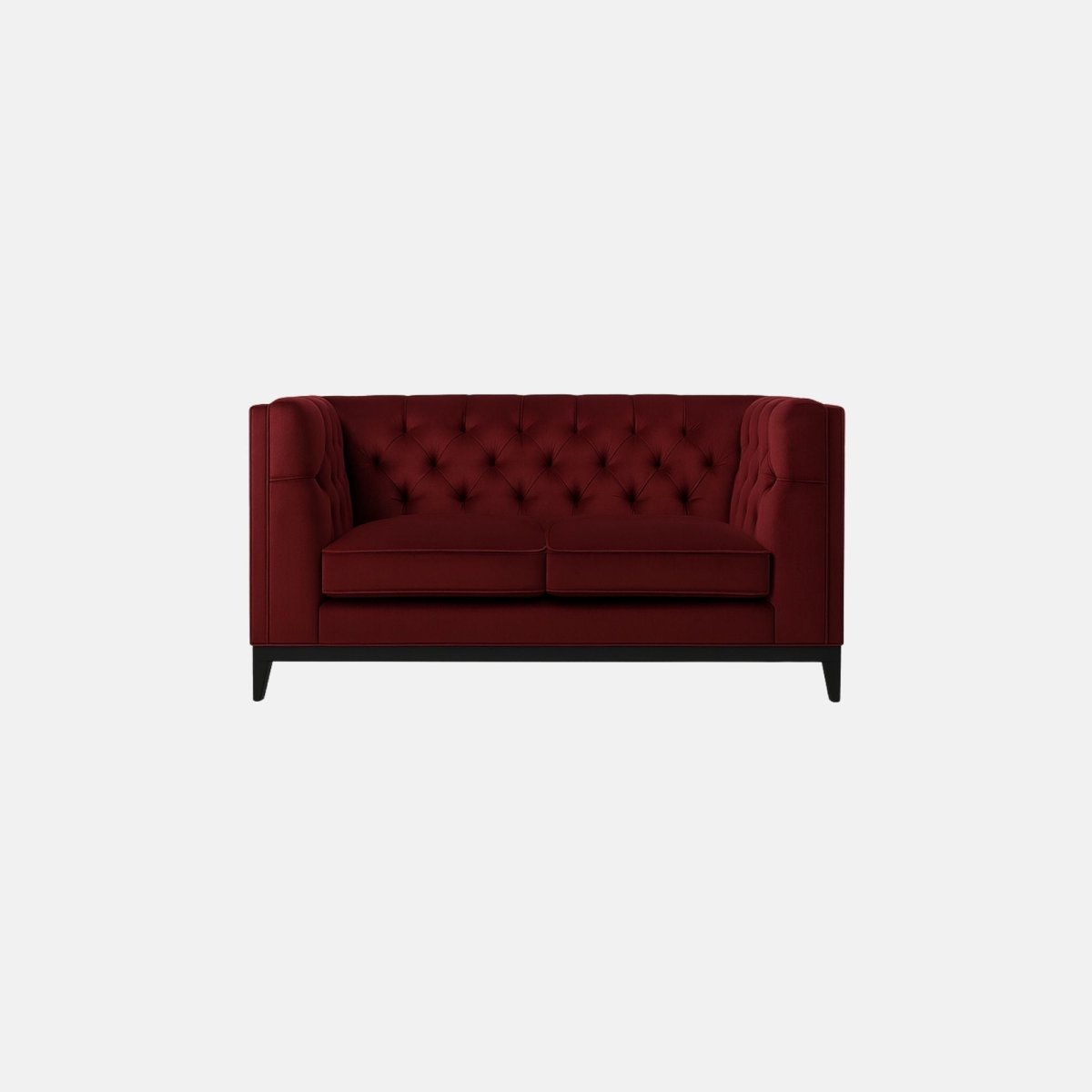 That’s a burgundy tufted sofa with a deep-buttoned back and sides — a design that resembles a modern Chesterfield. It has two seat cushions, straight square arms, and a solid dark wood base with tapered legs.