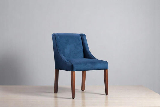 alt="Blue square dining chair upholstered in soft velvet with medium oak wooden legs"