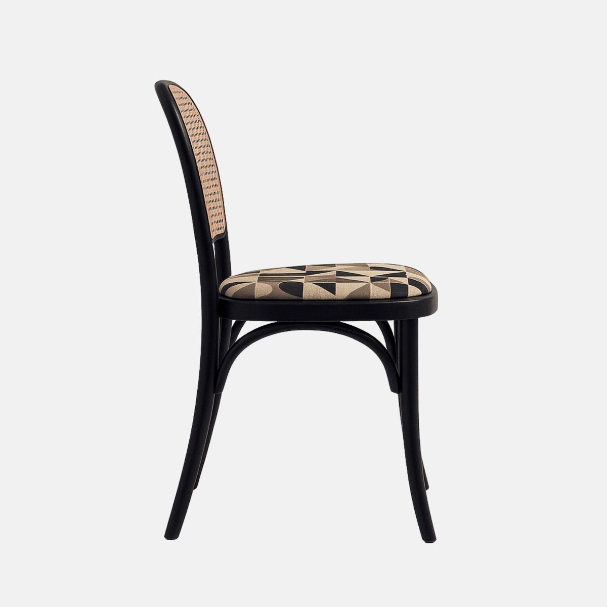 A black bentwood dining chair with a natural cane backrest and a cushioned seat upholstered in a beige and black geometric patterned fabric, shown from a straight side angle against a neutral background.
