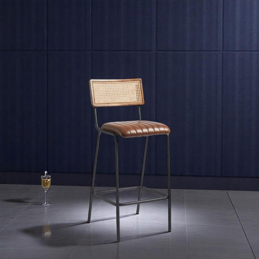 alt="Contemporary metal stool with rattan back and upholstered seat featuring sewing detail"