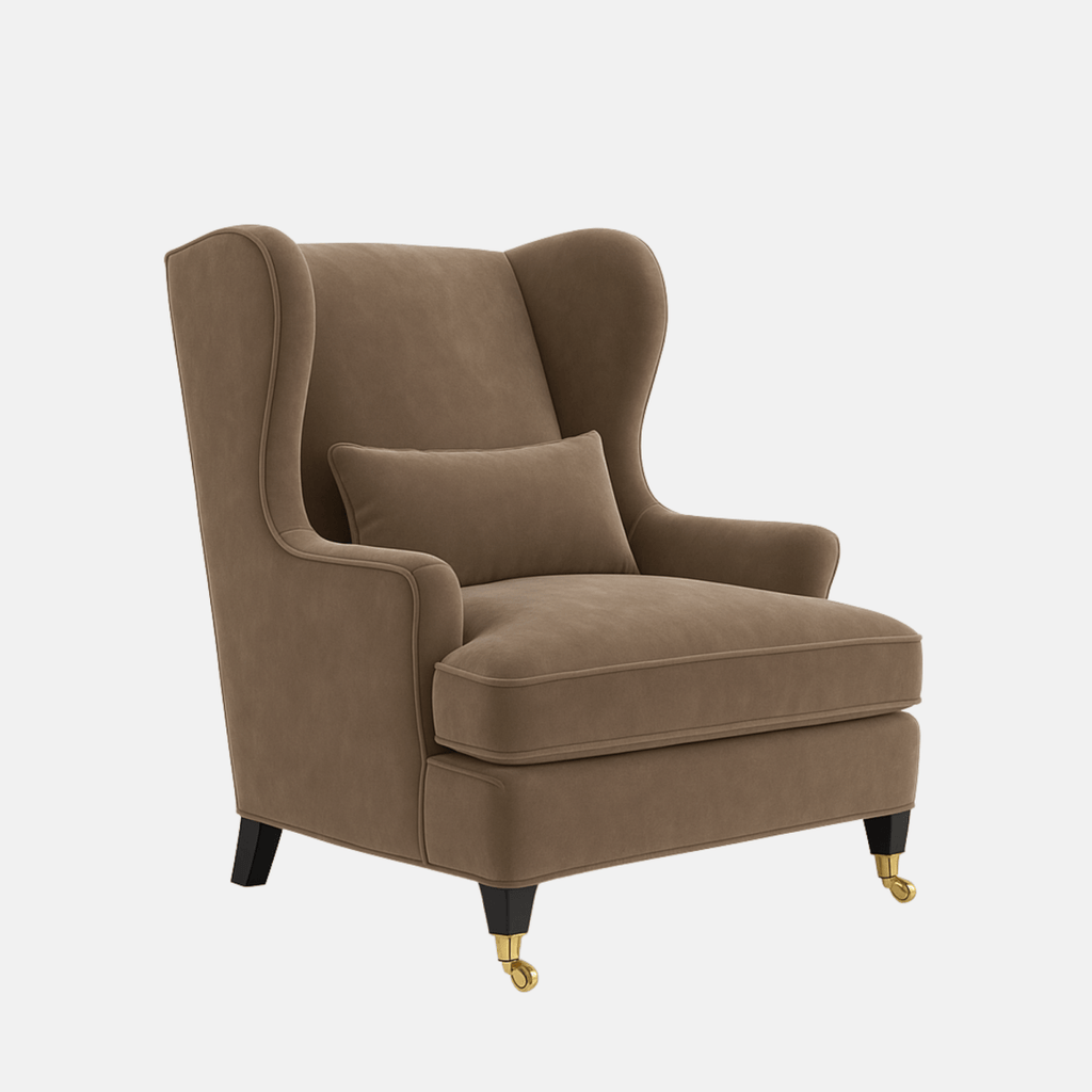 Brown upholstered wingback armchair with a matching lumbar cushion, rounded arms, and dark wooden legs with brass front castors