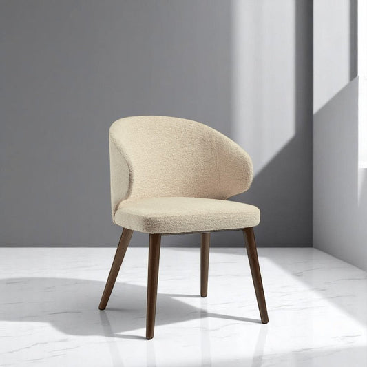alt="Wing back dining chair in soft cream fabric with stylish, supportive high backrest"