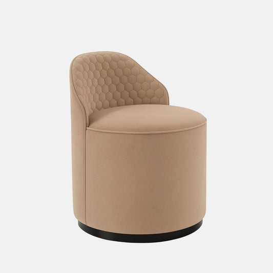 Beige velvet vanity chair with quilted hexagonal backrest and black round base modern upholstered accent chair for bedroom, dressing area, or hotel suite.