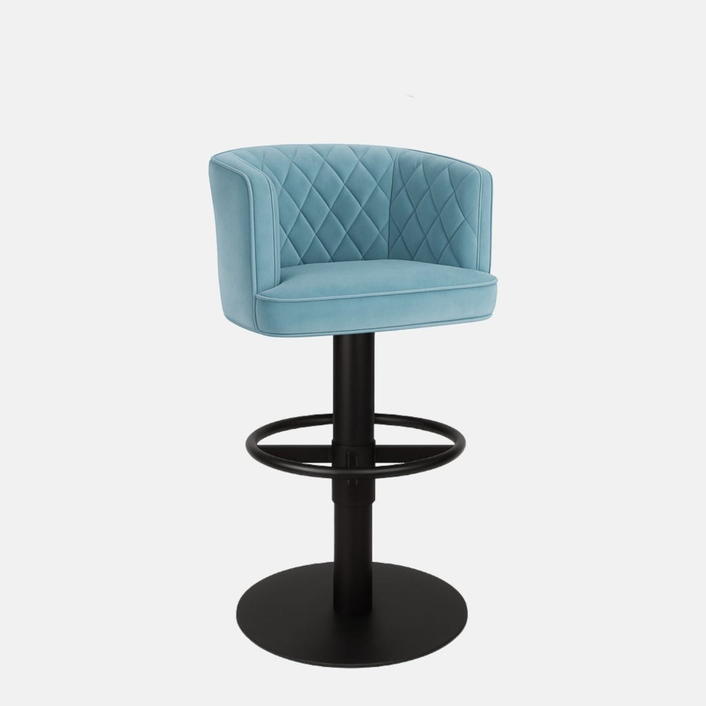 Light blue upholstered bar stool with a quilted backrest, circular black metal footrest, and round black base on a white background.