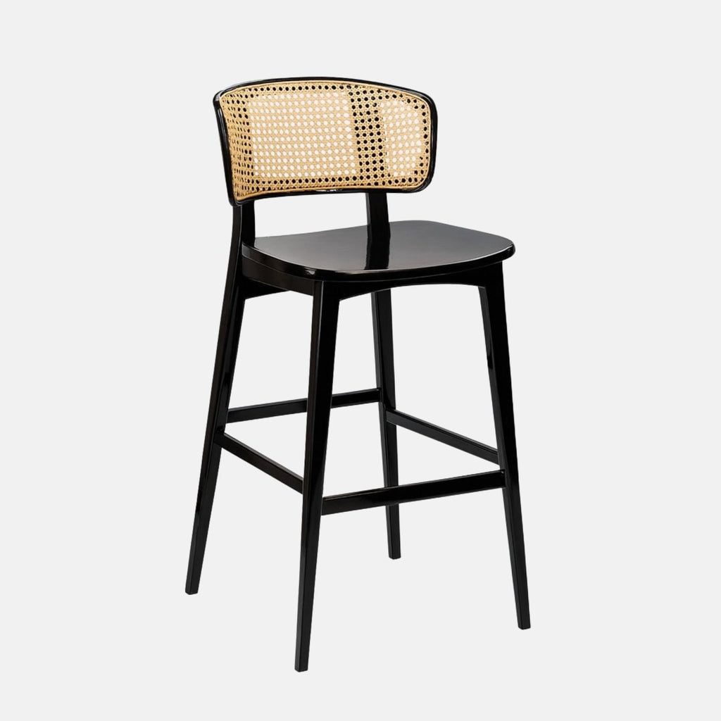 Modern bar stool with a glossy black wooden frame and a curved natural cane backrest, featuring a smooth black seat and footrest, set against a light grey background.
