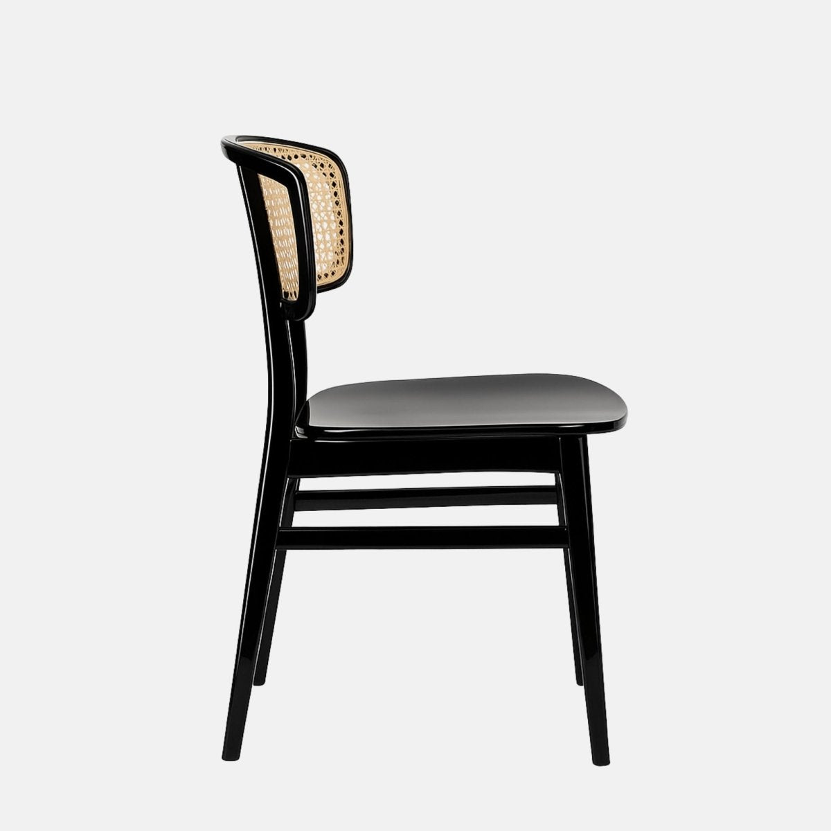 Contemporary dining chair with a glossy black wooden frame and a curved natural cane backrest, featuring a smooth black seat and clean minimalist design, set against a light grey background.