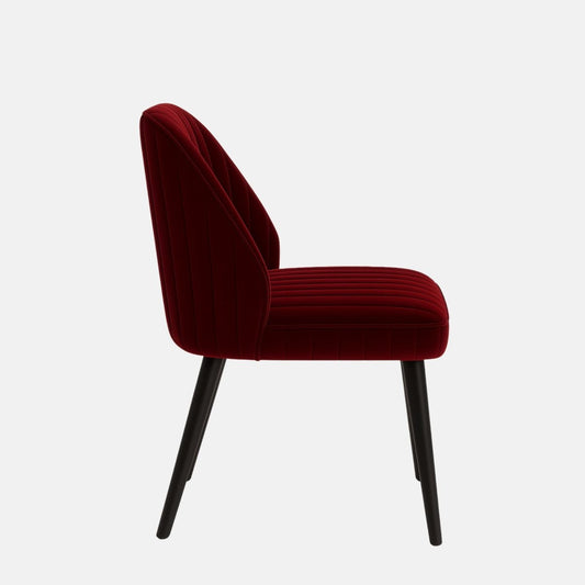 Elegant dining chair with black tapered legs and a fully upholstered seat and backrest in deep red velvet, featuring vertical channel stitching, set against a light grey background