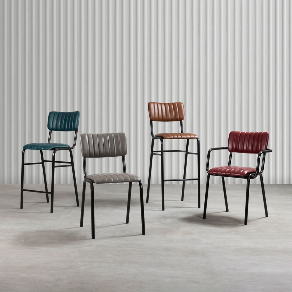 alt="Practical and stylish black stackable stool with padded leather seating and metal base"