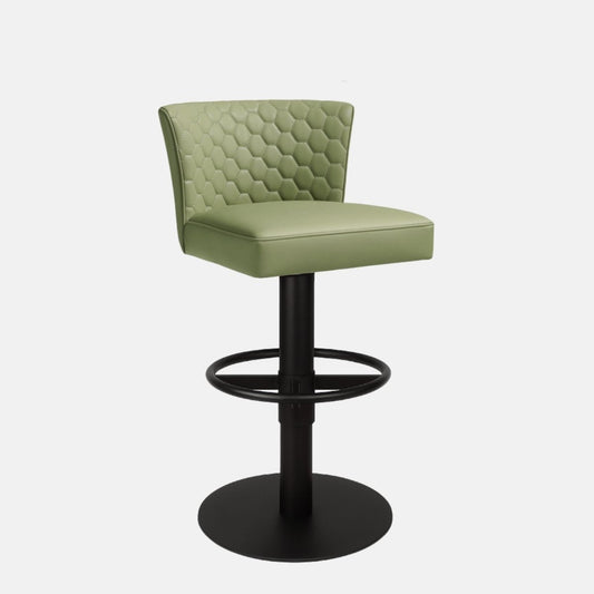 Front view of a green upholstered swivel counter stool with hexagon-quilted backrest, cushioned seat, black pedestal base, circular footrest ring and round base on a white background.