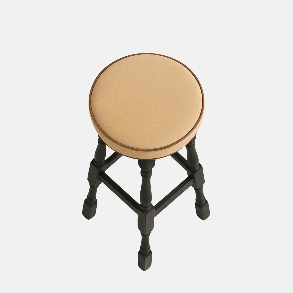 Tudor High Stool – tall black wooden bar stool with a round beige upholstered seat and turned legs, ideal for restaurants, bars, and modern interiors.