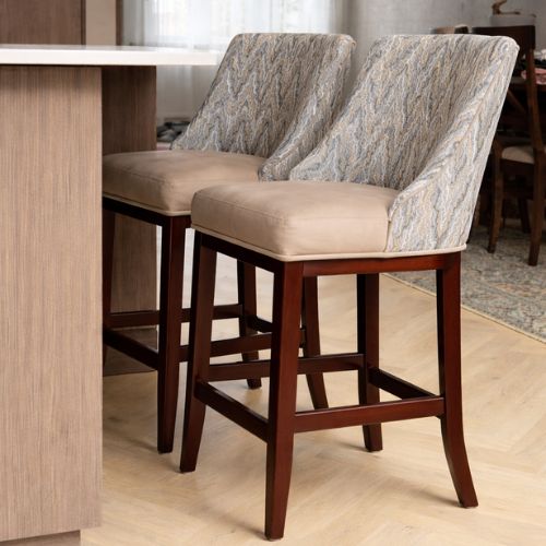 Modern upholstered counter height bar stools with wooden legs at kitchen island