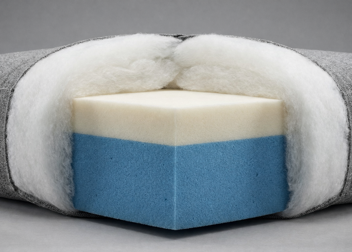 Cutaway view of upholstery foam and padding layers used inside a furniture cushion