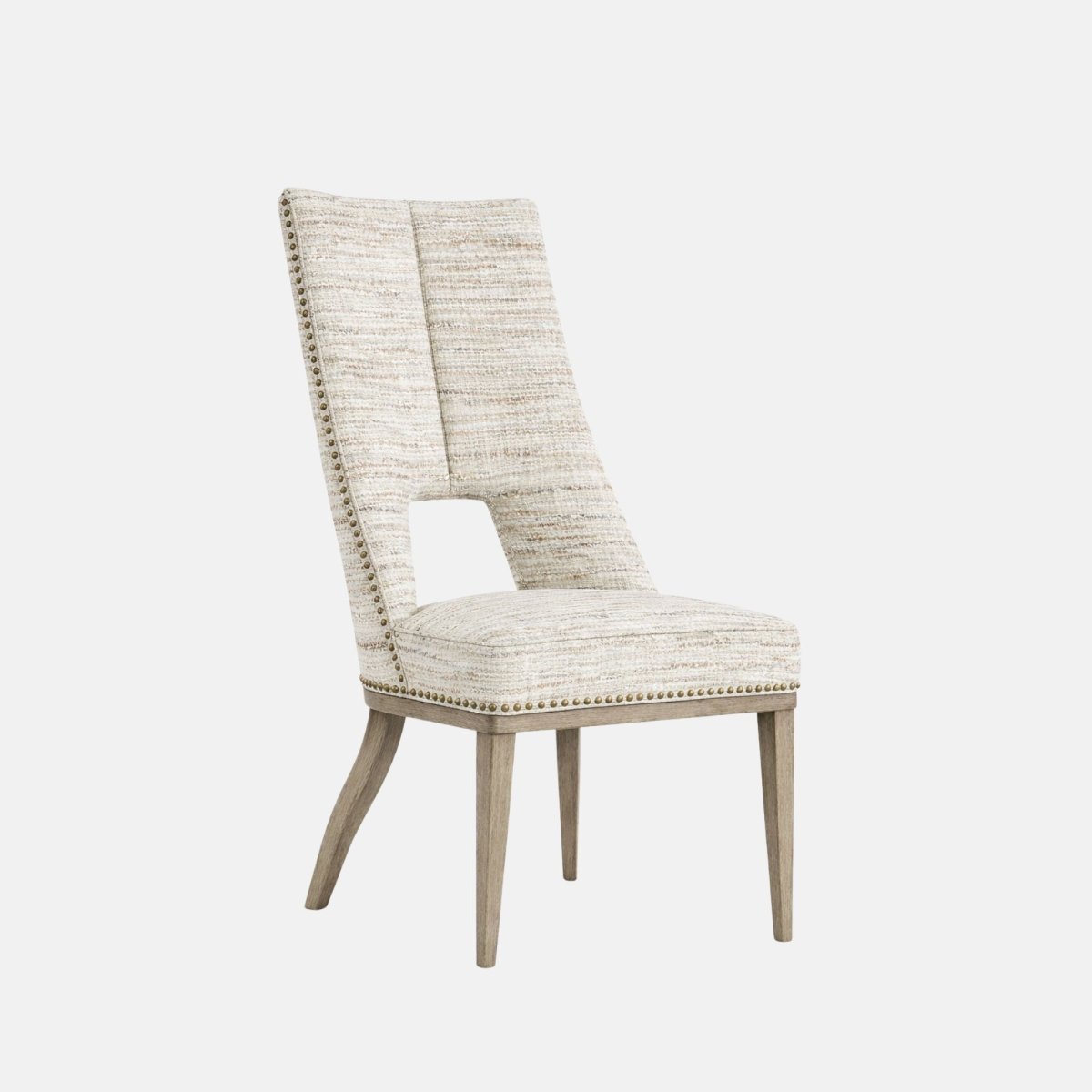 Upholstered dining chair in light beige textured fabric with a high back featuring a rectangular cut-out detail, nailhead trim, cushioned seat, and light wooden legs, shown on a white background