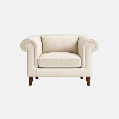 Elegant armchair with cream upholstery, rolled arms and cushioned seat, featuring wooden legs, ideal for lounges, hotels, and classic interiors