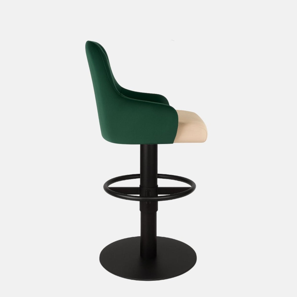 Green velvet 360° swivel bar stool with diamond-quilted backrest and cream upholstered seat on a black powder-coated metal base — bespoke modern counter stool.
